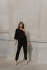 Olivia, an off-shoulder jumpsuit with three-quarter length sleeves, in black wool crepe